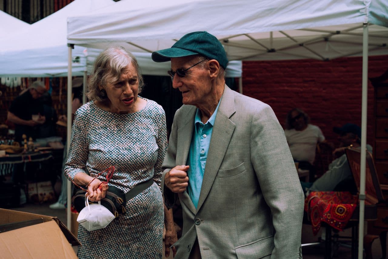An older couple shopping at a Spanish street market